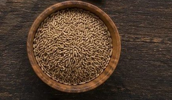 Cumin seeds in a wooden bowl