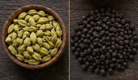 Green cardamom pods and black peppercorns